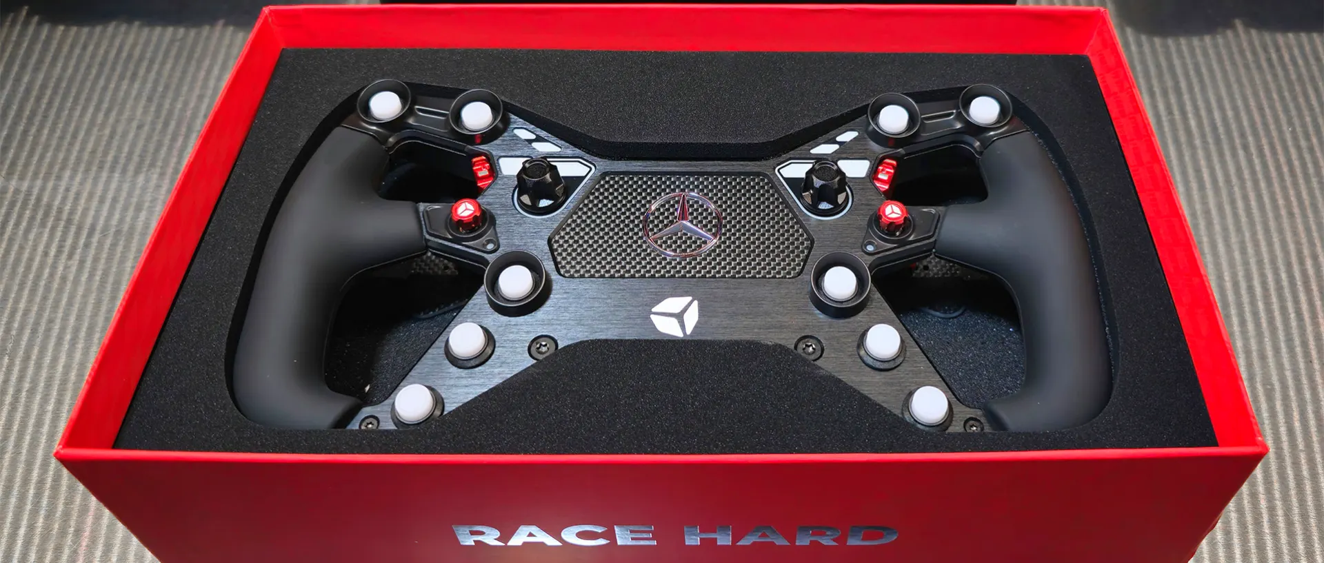 A racing steering wheel in its custom rigid box