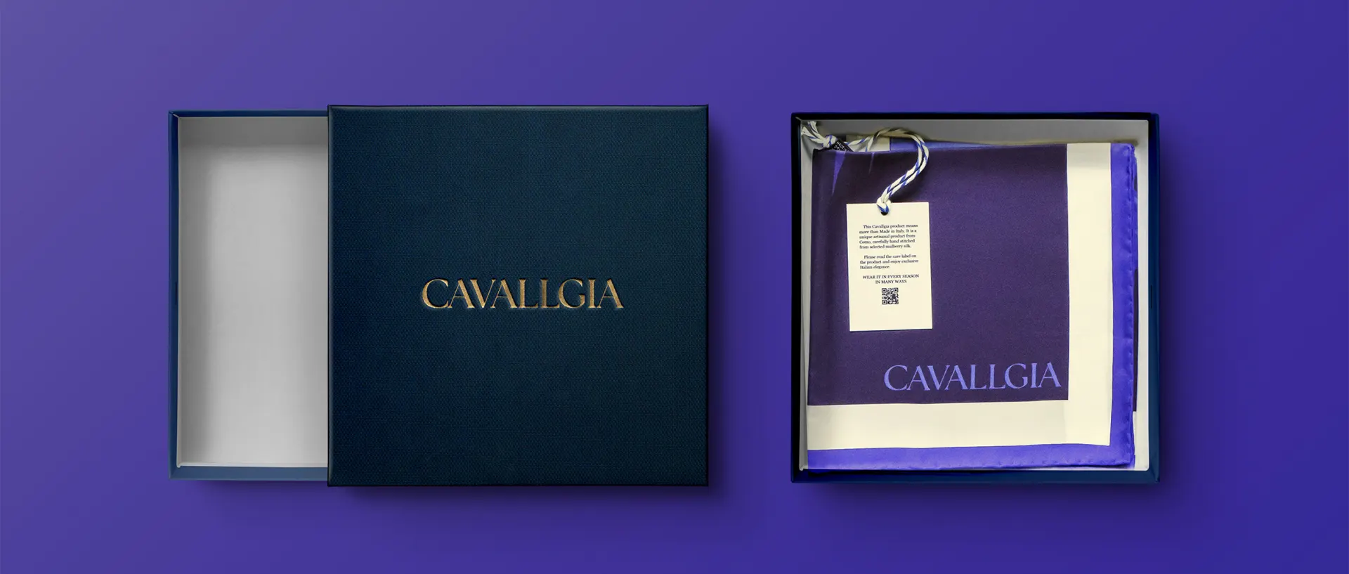 A deep blue box with gold foil lettering, open on a scarf